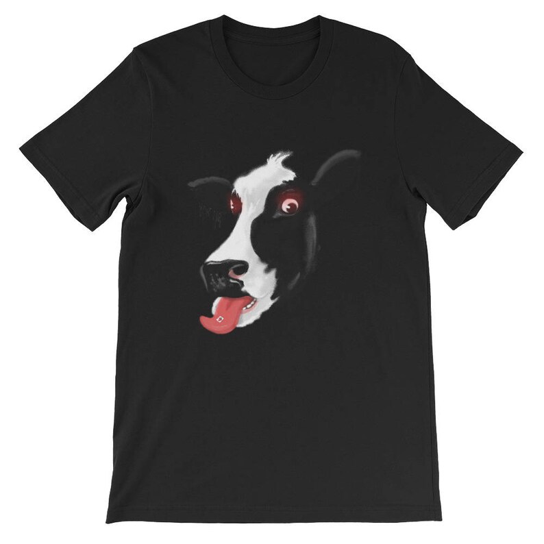 May include: Black t-shirt featuring a graphic of a cow's face with red eyes and a pink tongue sticking out.