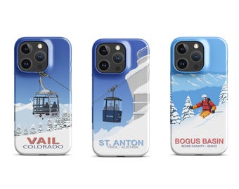 May include: Three different phone cases with winter sports themes. The first case features a blue and white design with a gondola and the text "Vail Colorado". The second case features a blue and white design with a gondola and the text "St. Anton Tirol - Austria". The third case features a blue and white design with a skier and the text "Bogus Basin Boise County - Idaho".