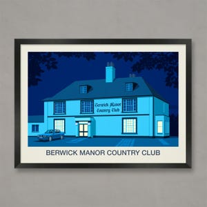 以下が含まれることがあります： 夜のBerwick Manor Country Clubの額入りプリント。建物は水色で、窓が照らされており、「Berwick Manor Country Club」の文字があります。青い車が前に駐車されています。「BERWICK MANOR COUNTRY CLUB」の文字が下にあります。