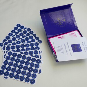 May include: A deck of 33 meditation cards and an index card in a blue box. The cards have a blue and white geometric pattern. The box has the title "Portals of Light Vision Cards 1" and the author "Judith Stone & Thomas".
