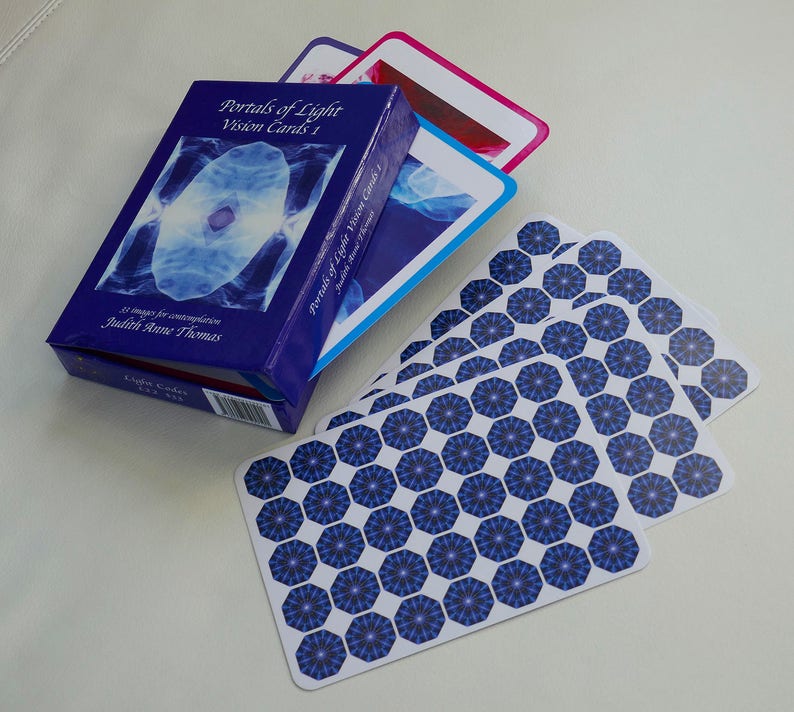 May include: A blue box with the title "Portals of Light Vision Cards 1" and the author "Judith Anne Thomas". The box contains a deck of cards with a blue and white geometric pattern.