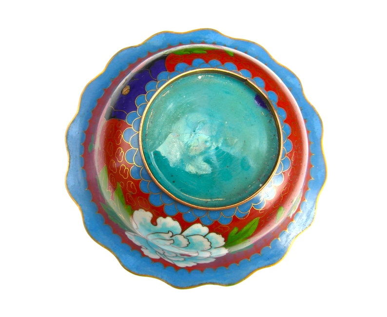 May include: A round, blue and red cloisonn&eacute; bowl with a scalloped rim. The bowl has a floral design and a turquoise centre.