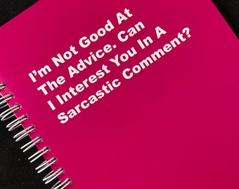 May include: A pink spiral bound notebook with the text "I'm Not Good At The Advice. Can I Interest You In A Sarcastic Comment?" printed in white.