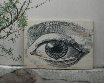 May include: A black and white illustration of a large eye on a white background. The eye is drawn in a detailed, realistic style.
