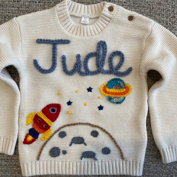 Personalised Baby Space Jumper with hand embroidered name, rocket, planet, moon and stars