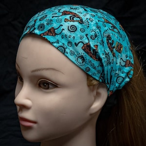 Bright turquoise elasticated headband with a design of the aztec fluteman Kokopelli, also perfect for Chemo head wear  bandana/Scarf