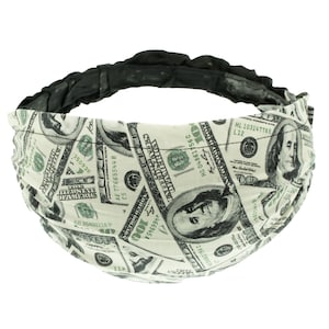 May include: A black headband with a white fabric covering featuring a repeated pattern of US $100 bills. The bills feature Benjamin Franklin's portrait and the text "THE UNITED STATES OF AMERICA" and "ONE HUNDRED DOLLARS".