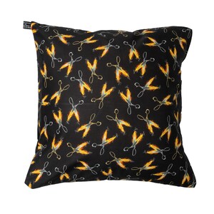May include: Black cushion with a repeating pattern of silver scissors on fire. The scissors are set against a black background.