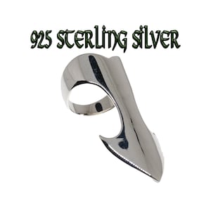 May include: A silver ring with an unusual, extended design. The ring has a smooth, curved band that flows into a pointed, stylized form. The text "925 STERLING SILVER" is displayed above the ring.