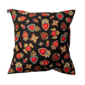 May include: Black cushion with a red, gold and blue pattern of stylised hearts with wings and halos.