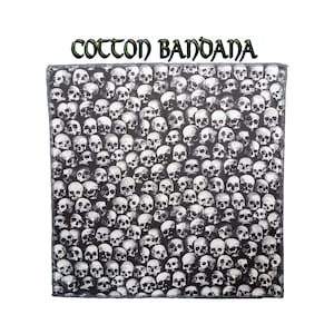 May include: A black and white cotton bandana featuring a skull pattern. The bandana is printed with hundreds of skulls, creating a bold and graphic design.