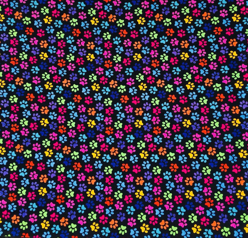 May include: A black fabric with a repeating pattern of colorful paw prints. The paw prints are in various shades of pink, blue, green, yellow, and orange.