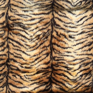 Ultra soft  and fluffy tiger faux fur fabric fabric sold by the metre or yard 150cm wide x 100cm or 91.5cm, it's also available to buy as half metre/yard or 10cm x 10cm sample.  Perfect for making cushions, scarves, apparel, fancy dress costumes etc.