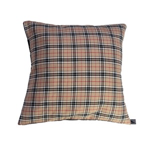 May include: A tan, black and red plaid cushion with a black border.