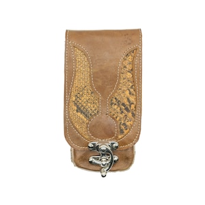 May include: A brown leather wallet with a snakeskin pattern on the front. The wallet has a silver clasp.