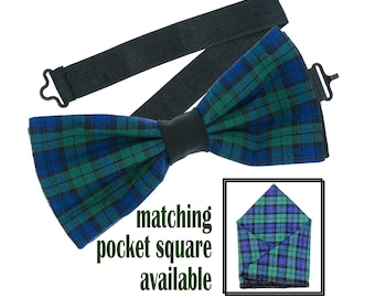 May include: A green, blue, and black plaid bow tie with an adjustable black elastic strap.  Matching pocket square available.
