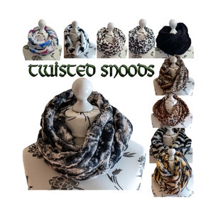 May include: A collection of twisted snoods in various colors and patterns, including leopard print, zebra print, and black. The snoods are made of soft, fuzzy fabric and are perfect for keeping warm in the winter.