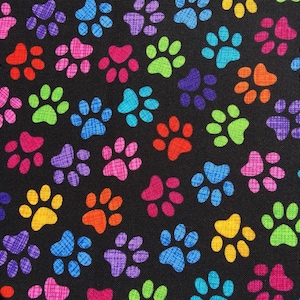 May include: A black fabric with a repeating pattern of colorful paw prints. The paw prints are in various colors, including red, orange, yellow, green, blue, purple, and pink.