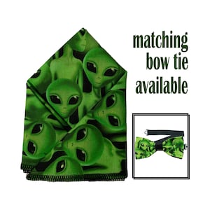 May include: Green fabric pocket square with a repeating pattern of alien faces. Matching bow tie available.