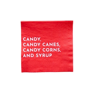 May include: A square, red paper napkin with the words "CANDY, CANDY CANES, CANDY CORNS, AND SYRUP" printed in white. The napkin has a textured pattern and is likely for a holiday or festive occasion.