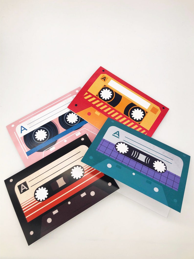 May include: Four colorful cassette tape cards with the letter "A" on each card. The cards are stacked on top of each other.