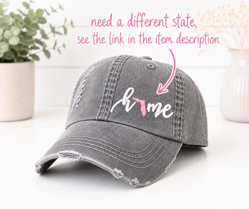 May include: Distressed gray baseball cap with the word "home" and a pink outline of the state of Florida. The cap has a curved brim and a worn, vintage look. The text "need a different state, see the link in the item description" is above the cap.