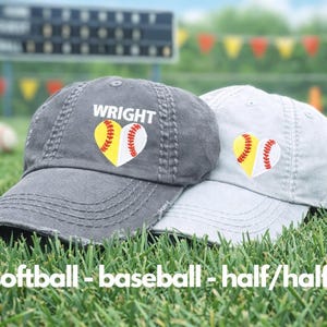May include: Two baseball caps, one gray and one light gray, rest on green grass. Each cap features a heart-shaped design combining a softball and baseball. The word "WRIGHT" is embroidered on the gray cap. The text "softball - baseball - half/half" is at the bottom.