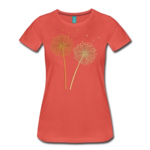 May include: A coral colored t-shirt with a gold embroidered design of two dandelions with seeds blowing in the wind.