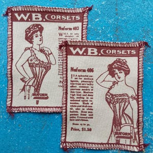 May include: Two vintage-style fabric squares with maroon trim and text, advertising "W.B. Corsets." Each features a detailed illustration of a woman in a corset. One reads "Nuform 403" and the other "Nuform 406."