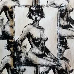 May include: A black and white illustration of a nude woman with short hair sitting on a stool. The illustration is framed with a white border and a black stitched edge.