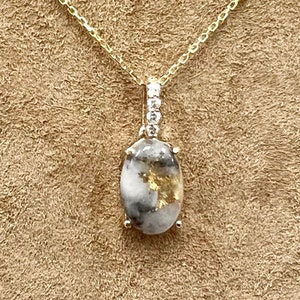 Oval Shaped Gold Quartz and Diamond Pendant Set in 14k Yellow Gold.