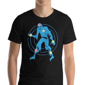May include: Black t-shirt featuring a blue graphic of a stylized figure with a target design behind it. The figure has a torn appearance and is adorned with yellow and red accents. The shirt is made of a soft material.