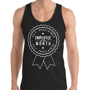 May include: Black tank top with a white graphic that reads "EMPLOYEE of the MONTH" inside a circular badge design. The text "SELF PROCLAIMED" is arched around the top and bottom of the badge. The tank top is sleeveless.
