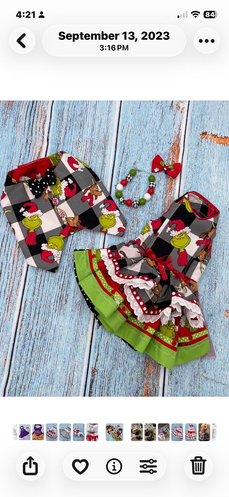 May include: A pet outfit set featuring a black and white buffalo plaid fabric with a Grinch character print. The set includes a vest with a black polka dot bow tie, a ruffled dress with red ribbon and white lace trim, and a beaded collar with a bow.