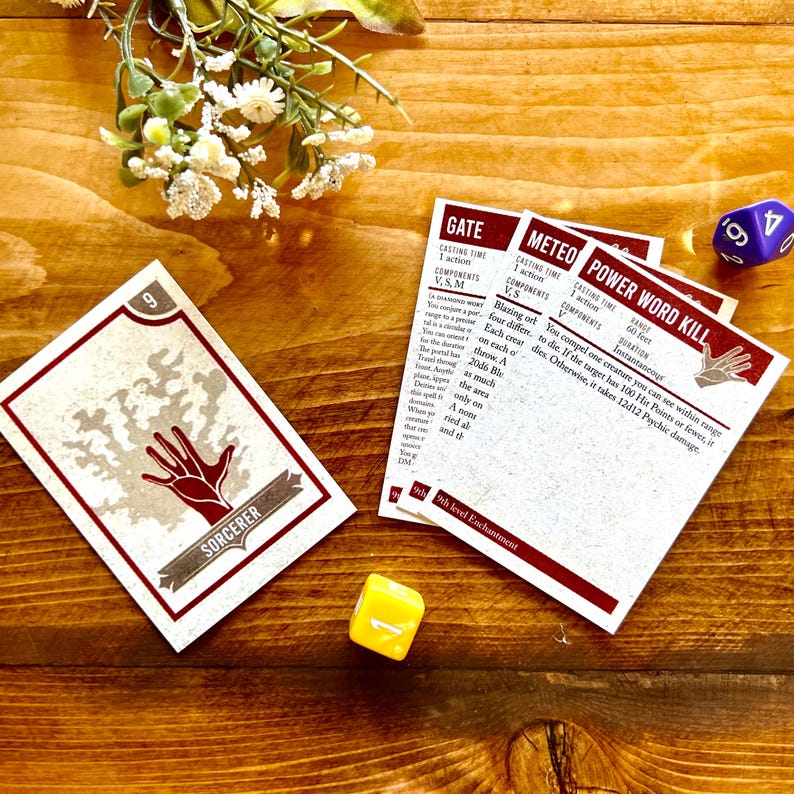 May include: A set of fantasy role-playing game cards with illustrations and text. The cards are on a wooden surface with a small yellow dice and a purple dice.