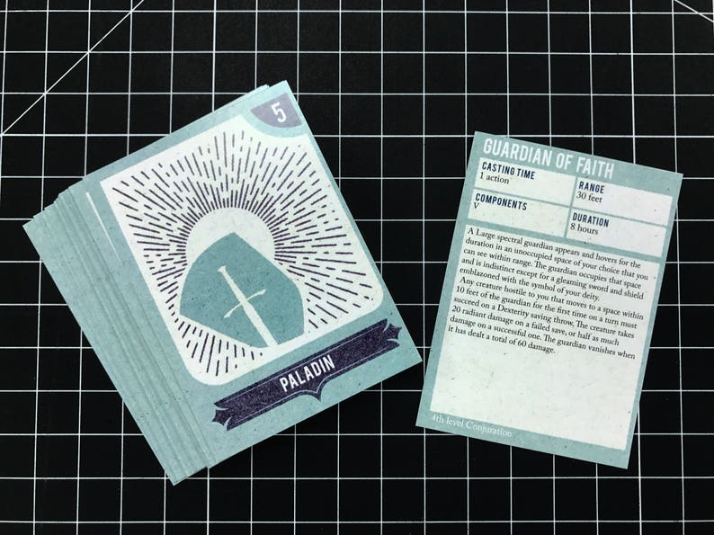 May include: A blue card with a white shield and sword design, labeled "Paladin" and the number "5". A second card, labeled "Guardian of Faith", describes a 4th level Conjuration spell with a range of 30 feet and a duration of 8 hours.