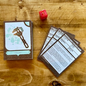 May include: A set of five brown cards with text and illustrations. The cards are for a tabletop role-playing game. The text on the cards includes "Stones", "Otiluke's Faithful Hound", "Mordenkainen's Faithful Hound", "Casting Time", "Components", "Range", "Duration", "A Tiny Silver Whistle, A Piece of Bone, and a Thread", "You conjure a phantom watchdog in an unoccupied space that you can see within range, where it remains for the duration until you dismiss it as an action, or until you move more than 100 feet away from it.", "The hound is invisible to all creatures except you and can't be harmed. When a Small or larger creature comes within 30 feet of it without first speaking the password that you specify when you cast this spell, the hound starts barking loudly. The hound sees invisible creatures and can enter the Ethereal Plane. It ignores illusions.", "At the start of each of your turns, the hound attempts to bite one creature within 5 feet of it that is hostile to you. The hound's attack bonus is equal to your spellcasting ability modifier + your proficiency bonus. On a hit, it deals 4d8 piercing damage.", "4th level Conjuration".
