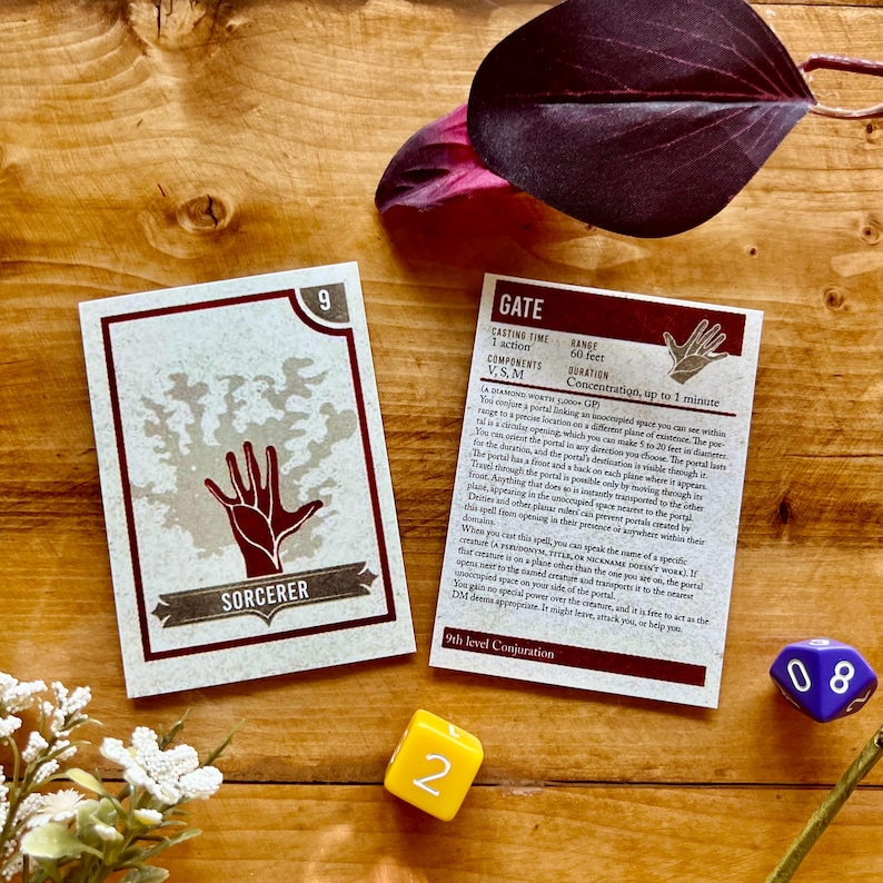 May include: Two cards from a Dungeons and Dragons game. The card on the left is a Sorcerer card with a hand reaching out from a tree. The card on the right is a Gate card with a description of the spell. The card is brown with red text.
