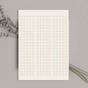 May include: A sheet of paper with a grid of 100 small, outlined stars in a light brown color. The stars are arranged in 10 rows of 10 stars each.