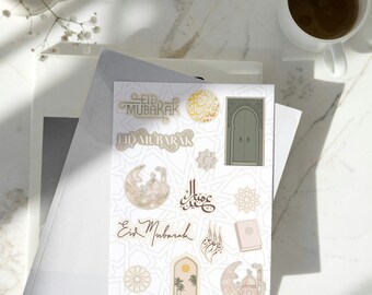 May include: A sheet of stickers with a white background and various designs related to Eid Mubarak. The stickers feature a mosque, crescent moon, stars, Arabic calligraphy, and the phrase "Eid Mubarak".