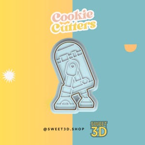 May include: A blue cookie cutter shaped like a Star Wars character, R2-D2. The cutter is on a yellow and blue background with the text "Cookie Cutters" and "@SWEET3D.SHOP SWEET 3D".