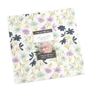 May include: A white fabric with a floral pattern featuring small blue, purple, and green flowers. The fabric is labeled "Seaglass Summer" by Moda Fabrics.