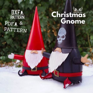 May include: Two Christmas gnomes, one red and one black, with white beards and hats. The black gnome has a skull design on its hat. The gnomes are sitting in the snow. The text "Christmas Gnome" is written above the gnomes. The text "DXF PATTERN PDF & PATTERN" is written in the top left corner of the image.