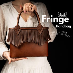 May include: A brown leather handbag with a fringe design. The bag has a rectangular shape with a top handle and decorative stitching. The words "Fringe Handbag" are displayed in white text.