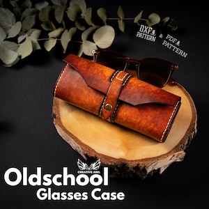 May include: A brown leather glasses case with a strap and stitching detail. The case is on a wooden surface with a pair of sunglasses inside. The text "Oldschool Glasses Case" is below the case.