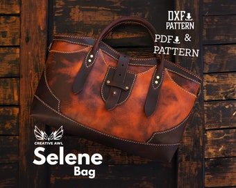 Puede incluir: Un bolso tote de cuero marrón con una correa de cuero marrón y una hebilla de latón. El bolso tiene un aspecto desgastado y está sobre una superficie de madera. El texto "Selene Bag" está impreso debajo del bolso.