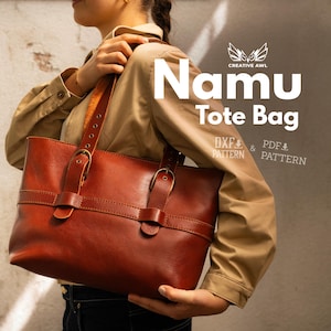 May include: A brown leather tote bag with a rectangular shape and two handles. The bag has a buckle closure and a strap detail. The text "Namu Tote Bag" is displayed in white, along with "DXF & PDF PATTERN".