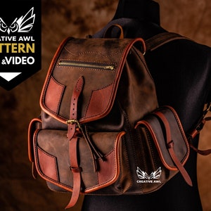 May include: A brown leather backpack with a flap closure and a buckle. The backpack has two side pockets and a zipped pocket on the front. The backpack is made of high-quality leather and has a distressed look. The backpack is a great option for everyday use or for travel.  "CREATIVE AWl PATTERN PDF & VIDEO" is printed on the left side of the image.