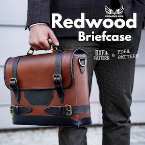 May include: A brown leather briefcase with black accents and gold-colored hardware is held by a person. The bag has a rectangular shape with a top handle and two front straps. The text "Redwood Briefcase" is displayed on the image.