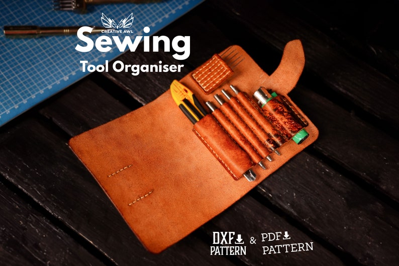 May include: A brown leather sewing tool organizer with a variety of tools inside, including a utility knife, awls, and a small screwdriver. The organizer is open and the tools are visible. The text "Sewing Tool Organiser" is printed on the front of the organizer. The text "DXF PATTERN & PDF PATTERN" is printed below the organizer.